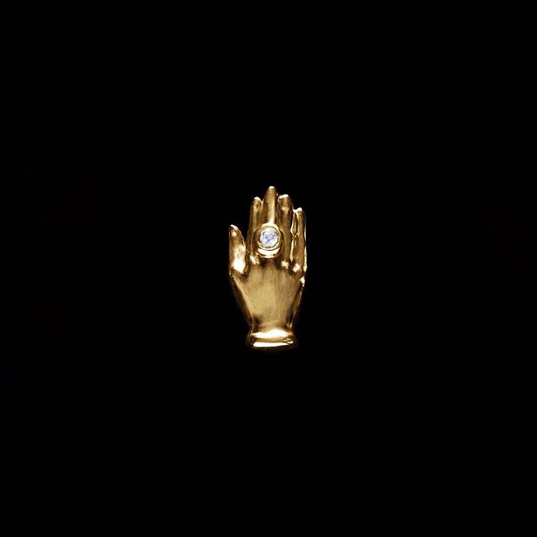 18k gold hand piercing adorned with a diamond