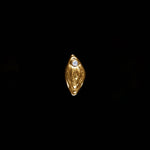 18k gold vulva piercing adorned with a diamond