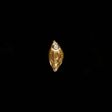 18k gold vulva piercing adorned with a diamond