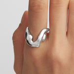 Model wearing a sterling silver ring of a abstract female body