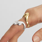 Hand model wearing rings of a melted female body in sterling silver and 18k gold plating