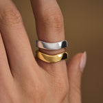 Model wearing organically shaped rings in sterling silver with 18k gold plating