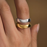 Model wearing organically shaped rings in sterling silver with 18k gold plating