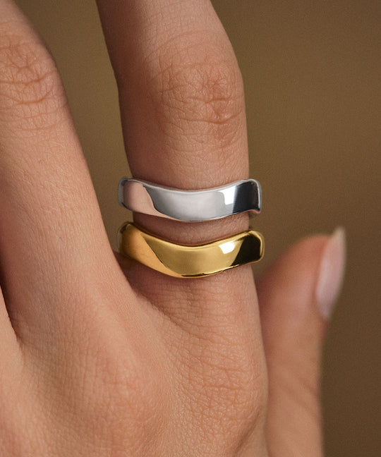 Model wearing organically shaped rings in sterling silver with 18k gold plating