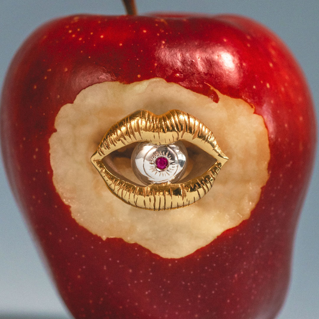 Surreal sterling silver ring with 18k gold plating of a mouth and eye with a ruby