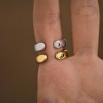 Model wearing abstract finger rings in sterling silver with 18k gold plating