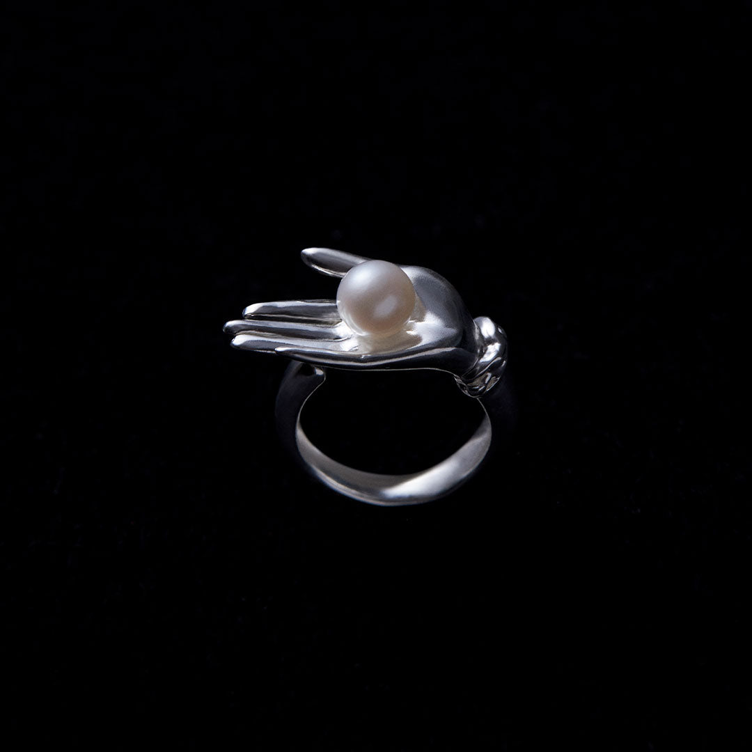Sculptural hand ring in sterling silver with button pearl