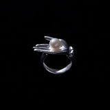 Sculptural hand ring in sterling silver with button pearl