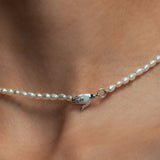 Model wearing Paola Vilas necklace in sterling silver with emerald and pearls