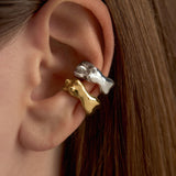 Model wearing sterling silver earcuffs with 18k gold plating featuring female bodies