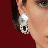 Model wearing sterling silver nipple earring with strands of natural pearls